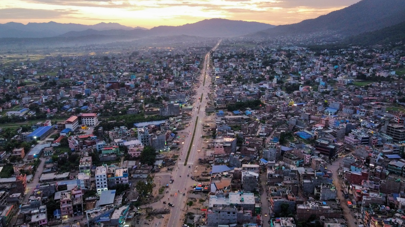 High-density settlements nestled at the foothills of mountains.