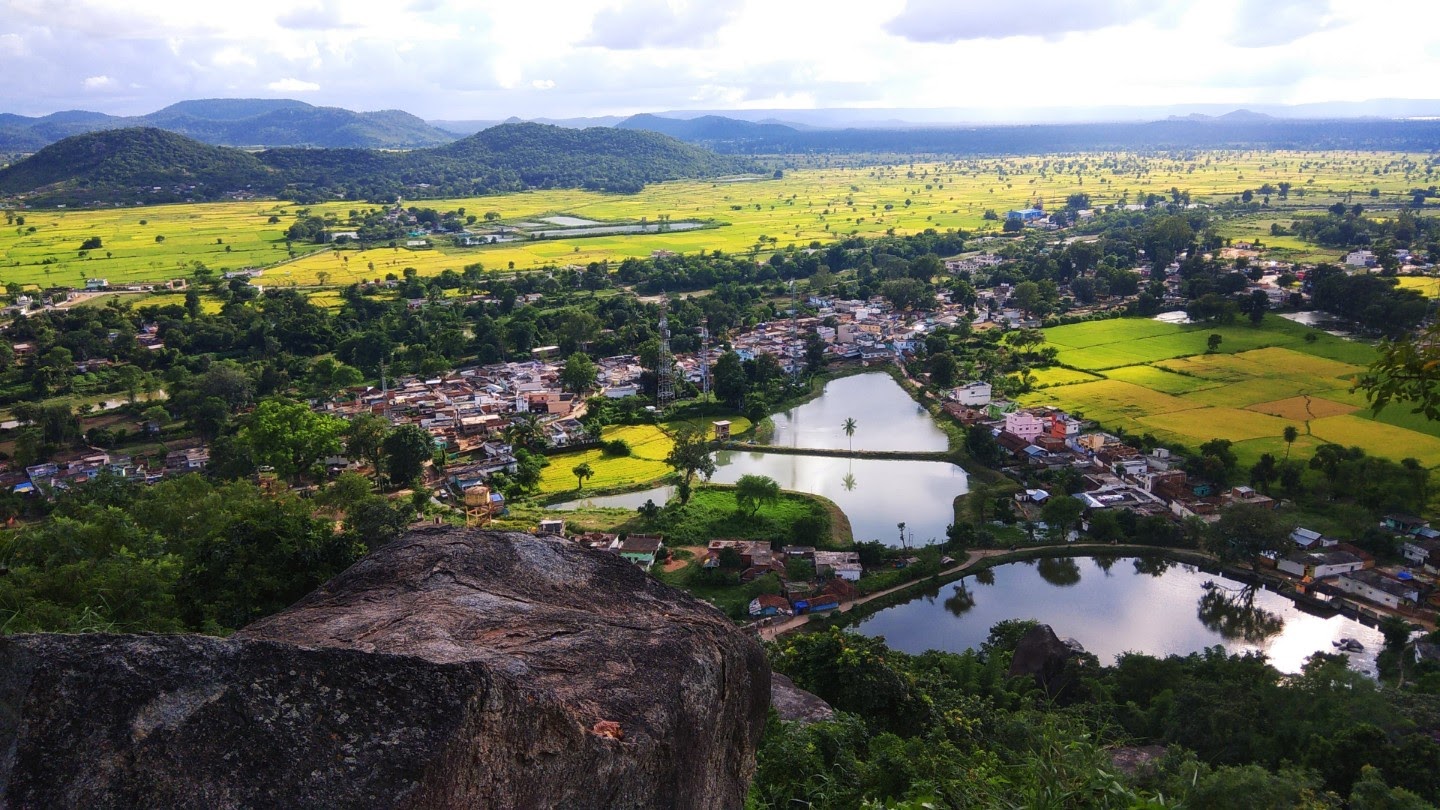 Rural settlements surrounded by fertile agricultural landscape with multiple waterbodies for irrigation.
