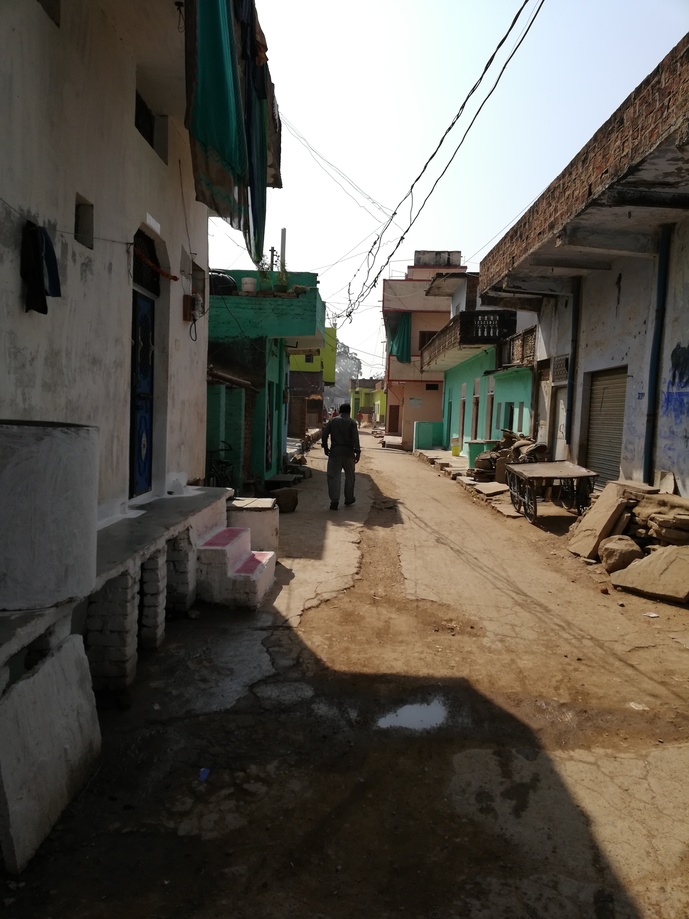 A typical street in Nirwari village displaying narrow lanes and a low-economic housing pattern.