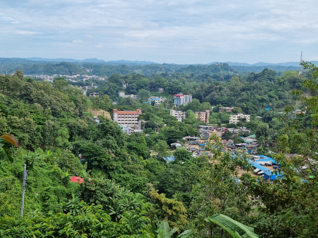 Bandarban town, characterised by high-rise and commercial buildings surrounded by greenery.