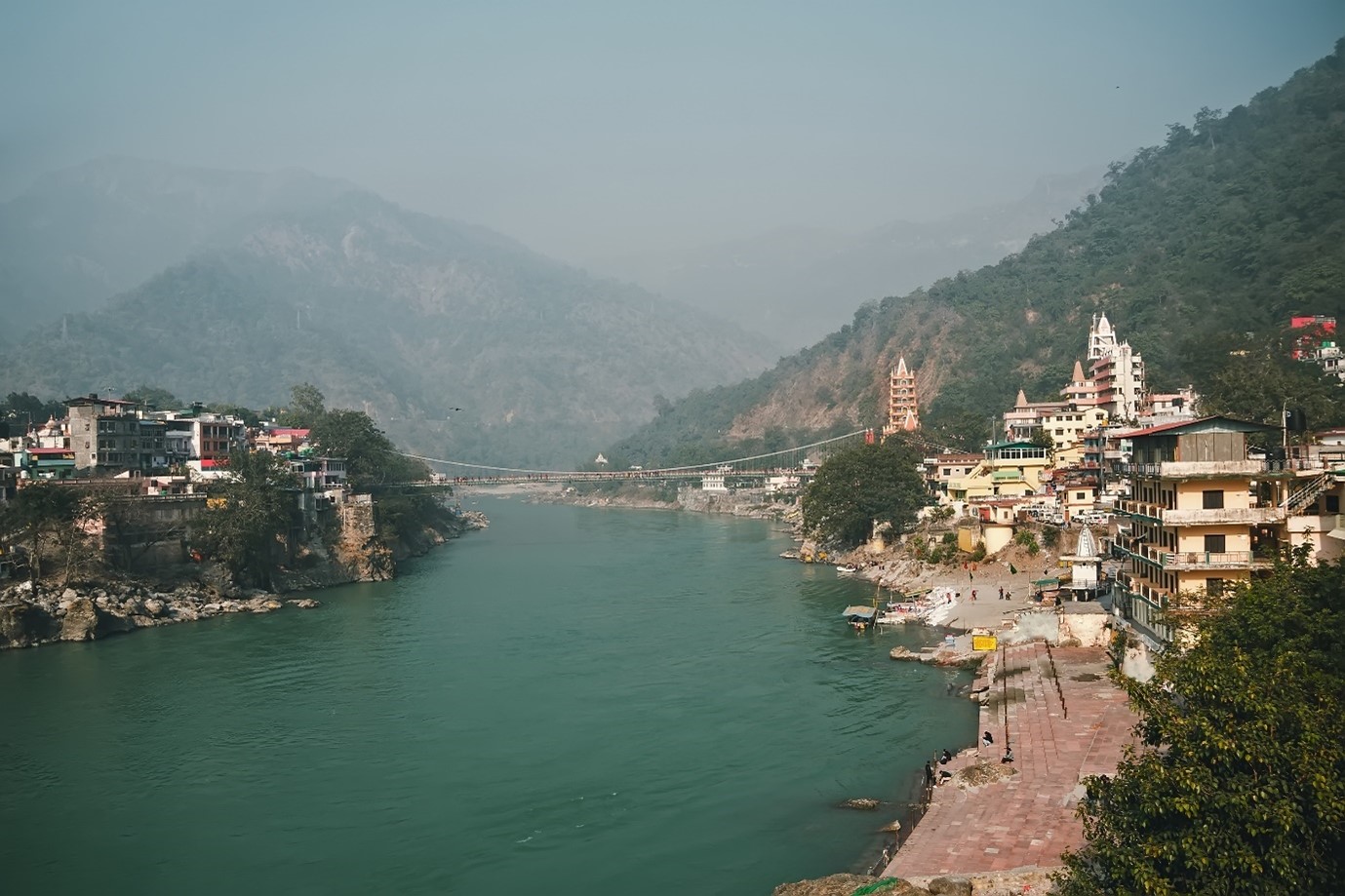 View of Ganga River embankment and Lakshman Jhula bridge, Rishikesh
